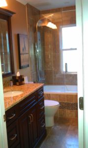 granite counter on new vanity and tiled jacuzzi tub/shower